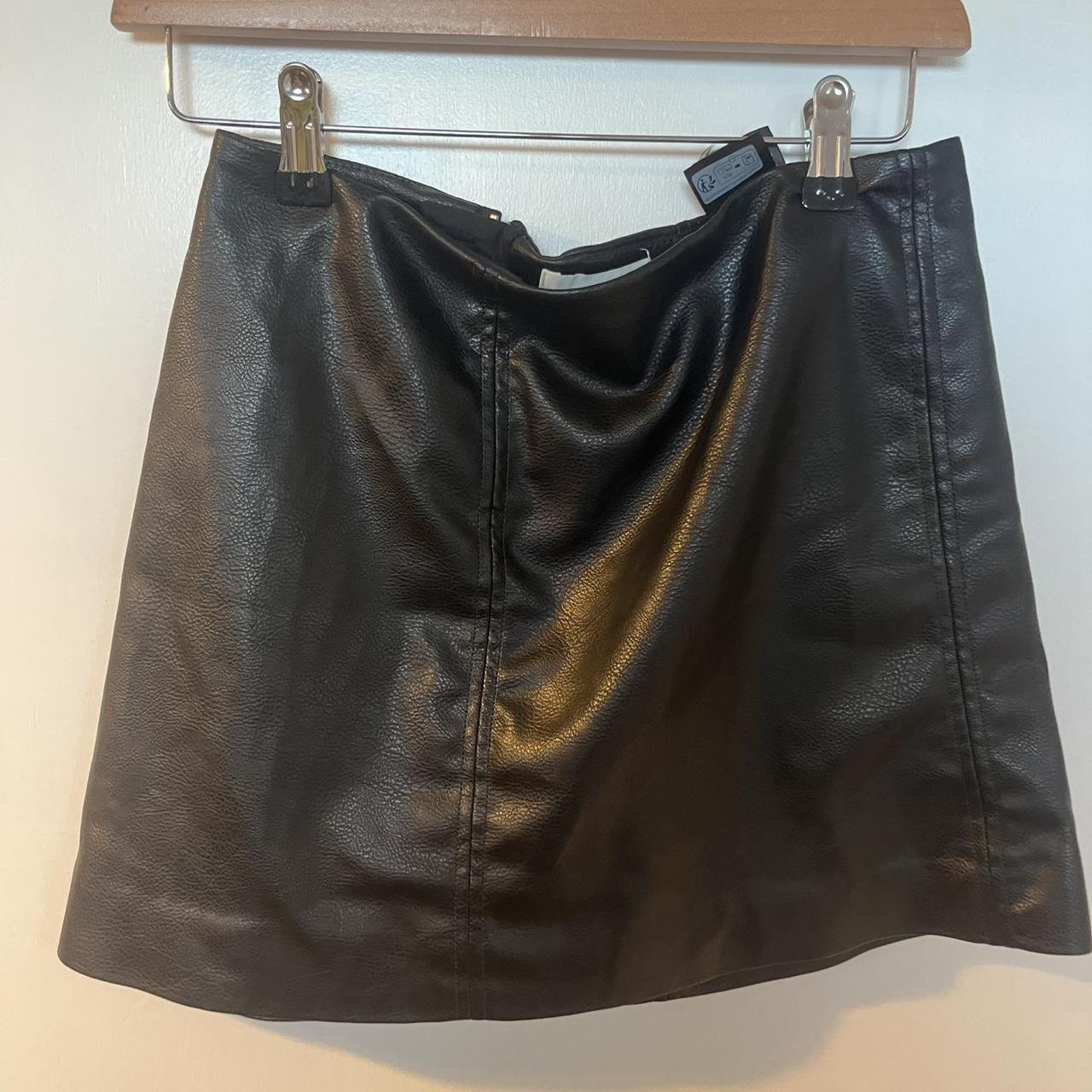 Black faux leather mini skirt with zipper and buckle detail